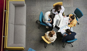 A group of business students sat around a desk