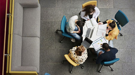 A group of business students sat around a desk