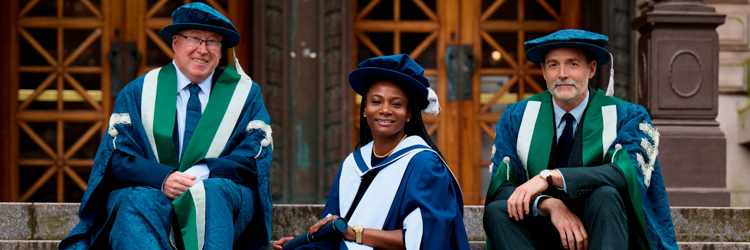 QMU graduate Fatou sat on the steps of the usher hall