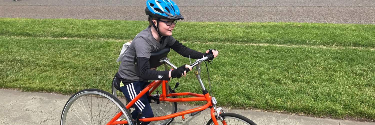 Image of child on frame running bike
