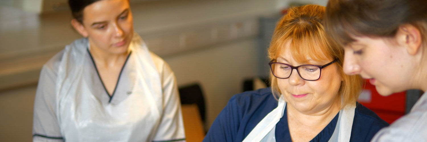 A nursing lecturer alongside student nurses in one of our teaching facilities.